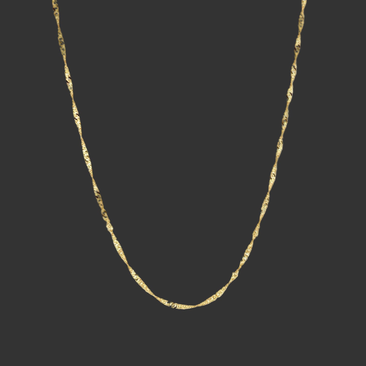 Gold chain necklace on a white background