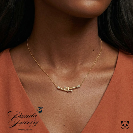 Gold necklace with a subtle design worn by a person