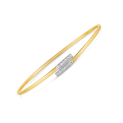 Gold bangle with a diamond bar design on a white background