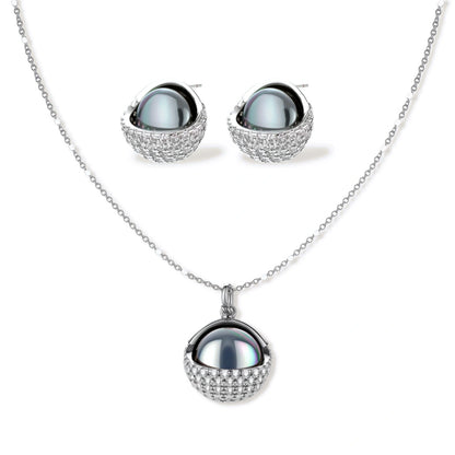 Silver gray Tahitian-style pearl pendant necklace and matching pave zirconia stud earrings set on cream background.