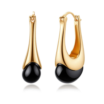 Gold-plated drop earrings featuring black agate stones with hoop closure on white background, showing elegant teardrop design.