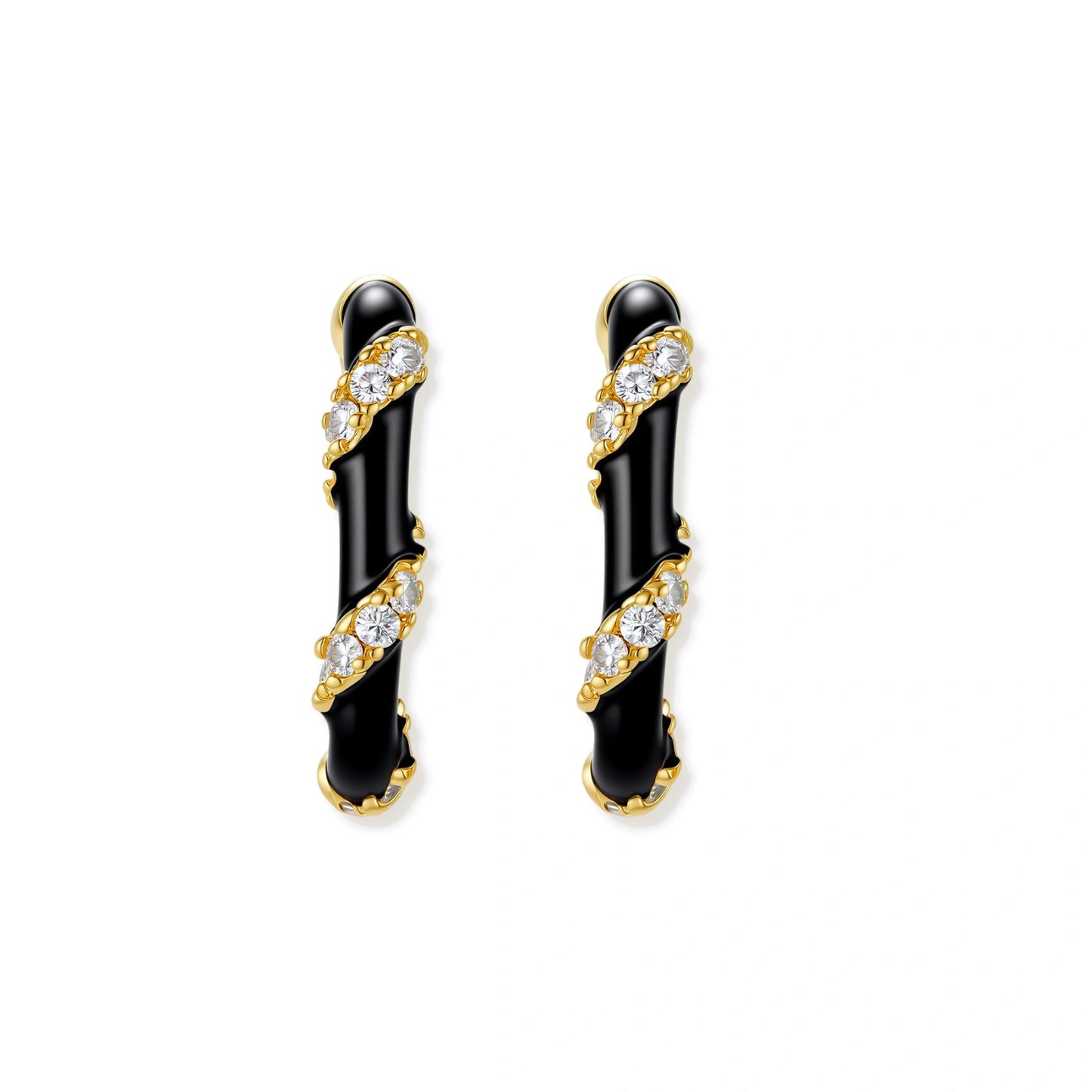 Small gold-plated hoop earrings with black enamel stripes and cubic zirconia crystals on white background.