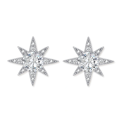 Sterling silver star-shaped stud earrings with brilliant moissanite center stones and pavé details on neutral background.