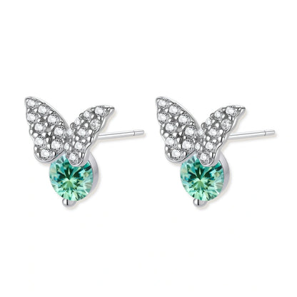 Sterling silver butterfly stud earrings with crystal wings and mint green center stones on cream background.