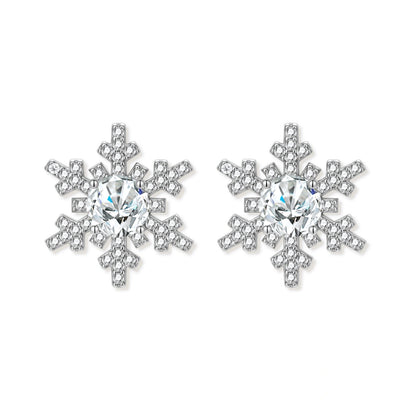 Sterling silver snowflake stud earrings with brilliant moissanite centers and intricate geometric patterns on cream background