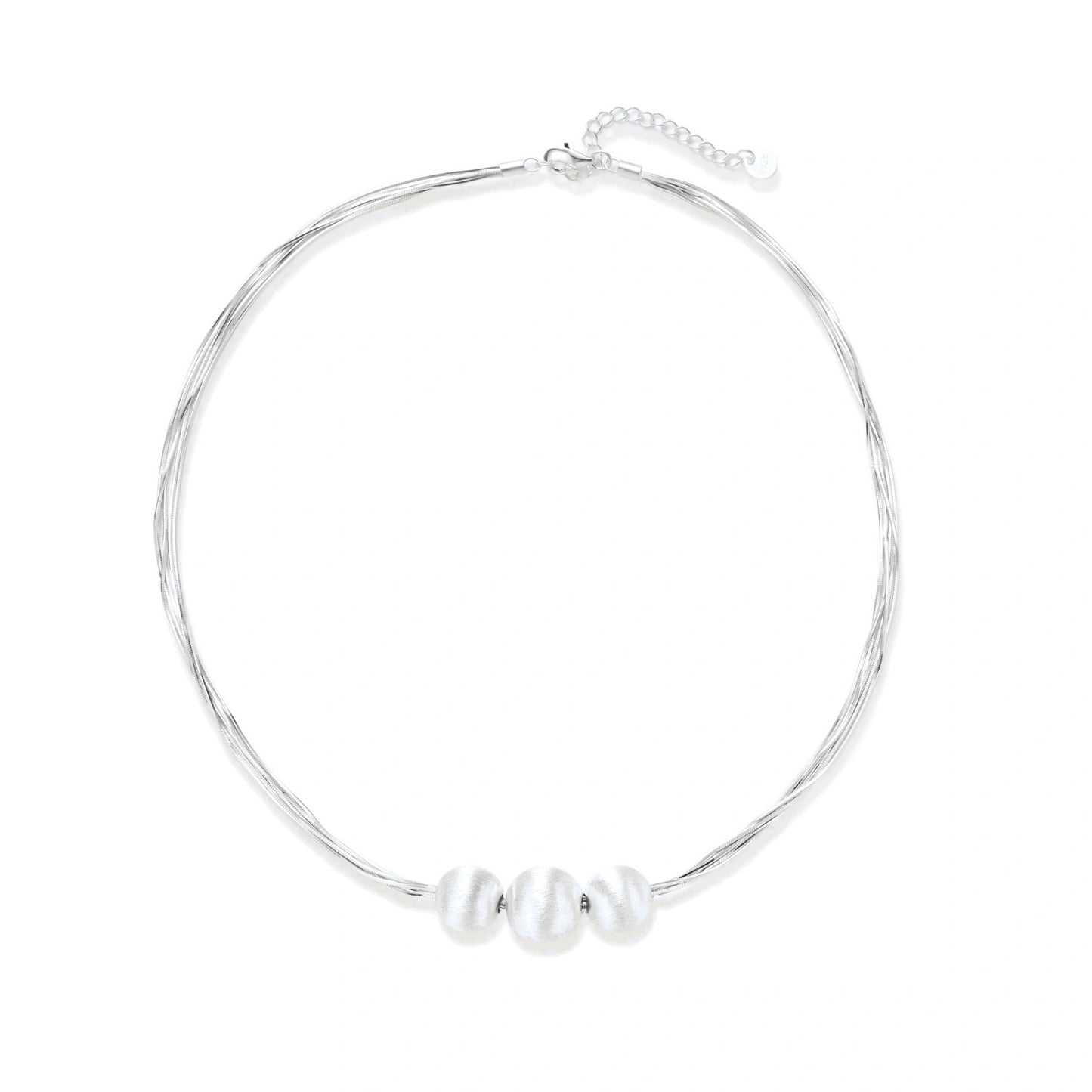 Sterling silver multi-strand necklace with three brushed round beads on cream background
