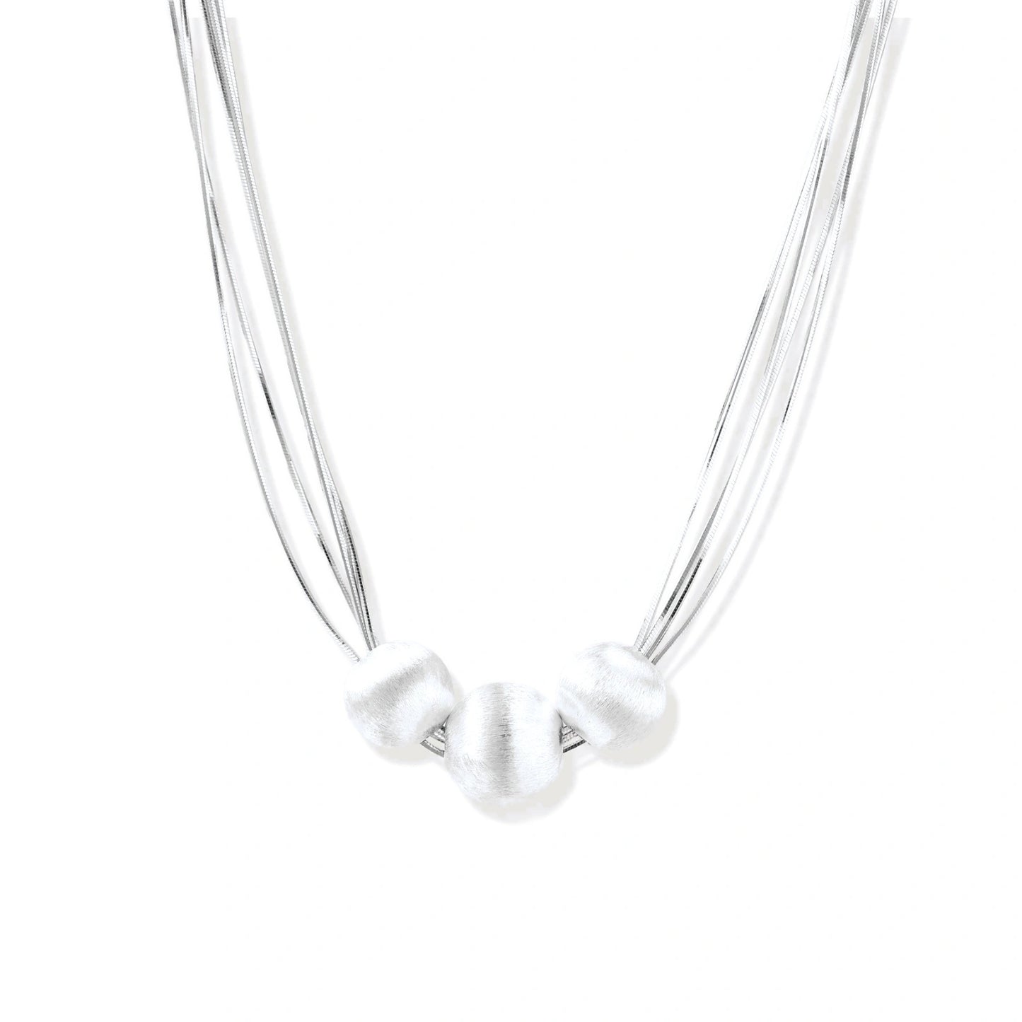 Sterling silver multi-strand necklace with three brushed round beads on cream background