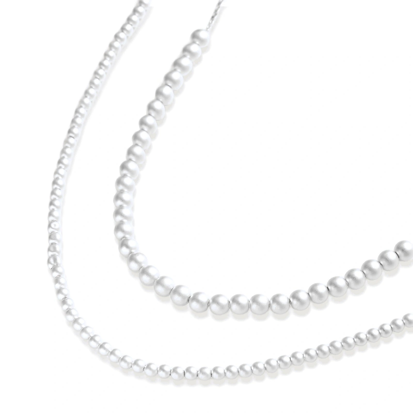 Long sterling silver beaded necklace with graduated sphere design, toggle clasp, and delicate chain extension on white background