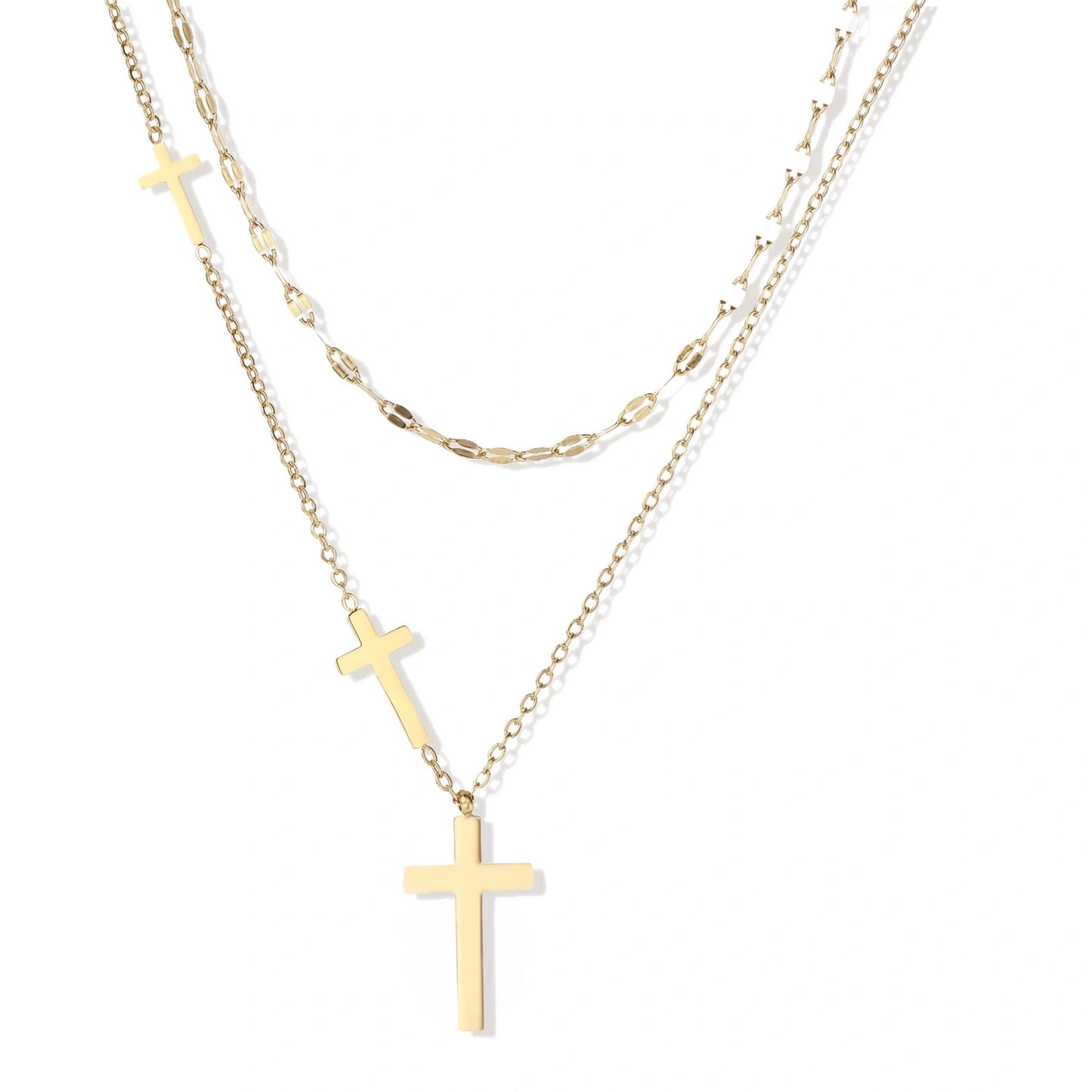 Three-layered gold necklace set with graduated cross pendants in mixed chain styles on white background.