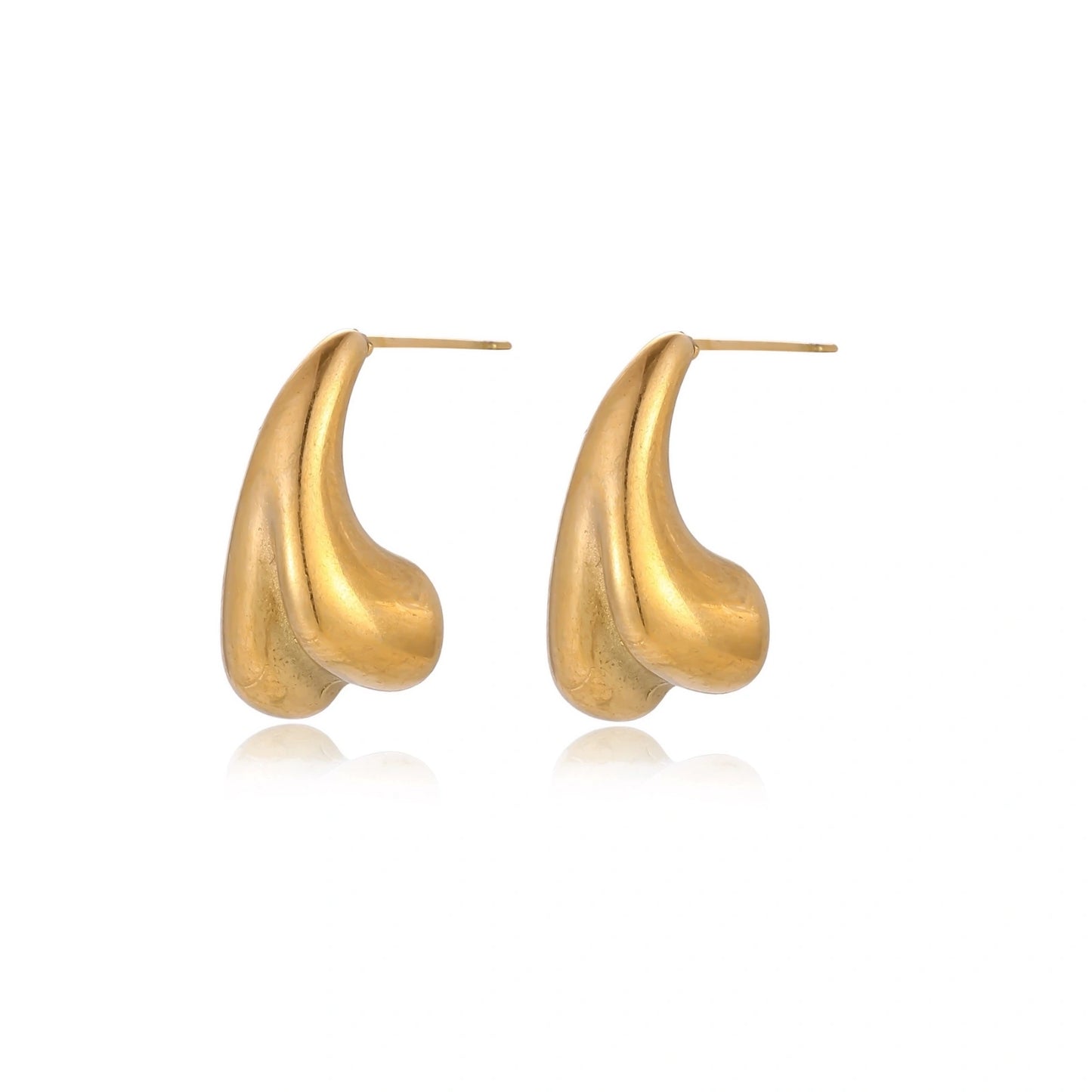 Organic sculptural gold stud earrings with fluid matte finish on cream background