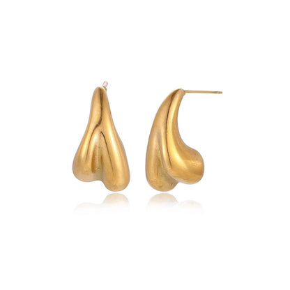 Organic sculptural gold stud earrings with fluid matte finish on cream background