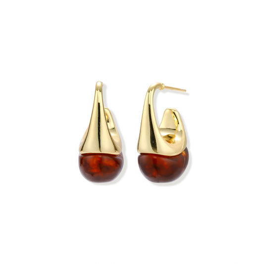 Modern drop earrings with curved gold-plated copper tops and amber resin bottoms creating an organic teardrop silhouette.