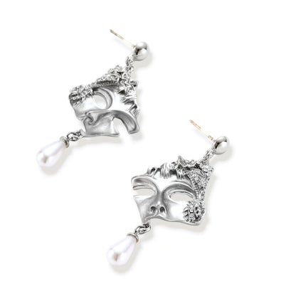 Ornate silver-toned masquerade mask jewelry set featuring rhinestone details and pearl drop earrings on white background.