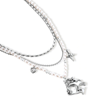 Ornate silver-toned masquerade mask jewelry set featuring rhinestone details and pearl drop earrings on white background.