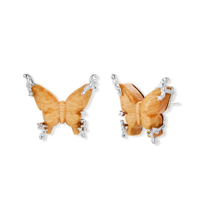 Amber wood butterfly pendant necklace with dangling chains and matching carved wood butterfly earrings on white background.