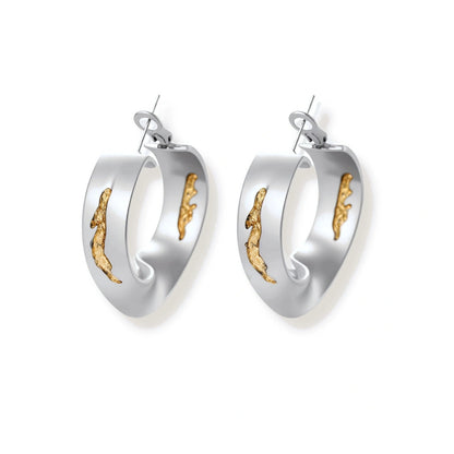 Artistic jewelry set featuring curved silver pendant with gold veining on black cord plus matching asymmetrical hoop earrings