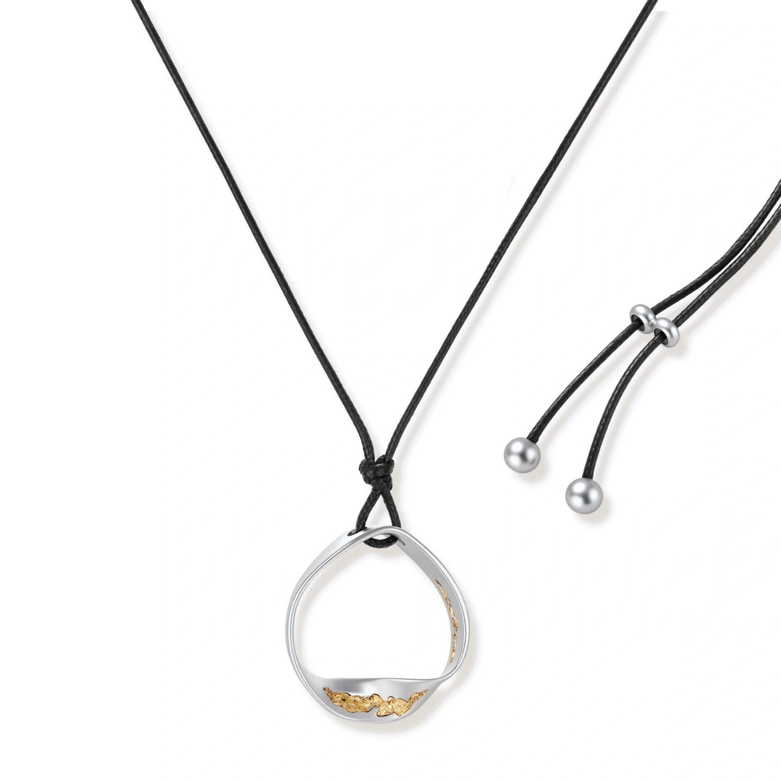 Artistic jewelry set featuring curved silver pendant with gold veining on black cord plus matching asymmetrical hoop earrings