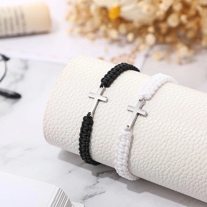 Close-up of black and white cross bracelet woven cord detail