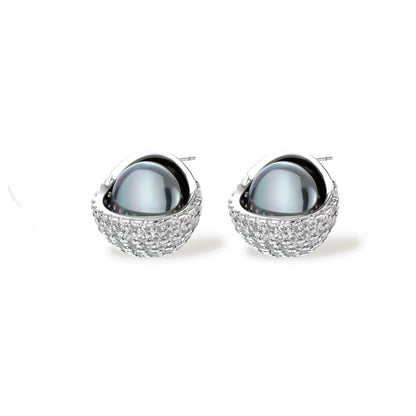 Silver gray Tahitian-style pearl pendant necklace and matching pave zirconia stud earrings set on cream background.