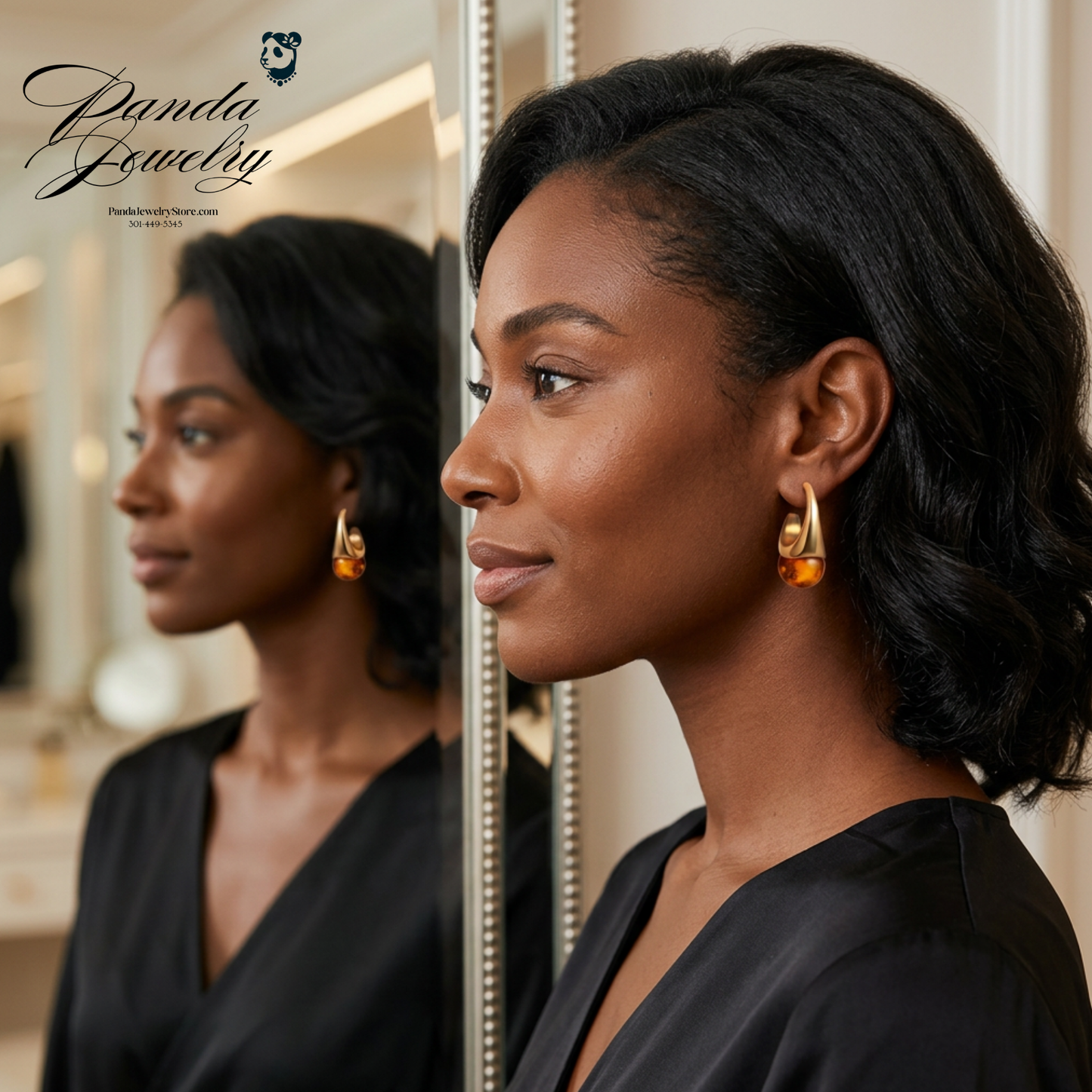 Amber Flow drop earrings — lifestyle showing a beautiful woman of color wearing a pair of tapered gold crown while admiring herself in a mirror