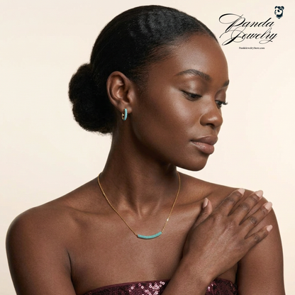 Woman wearing a necklace with a plain background