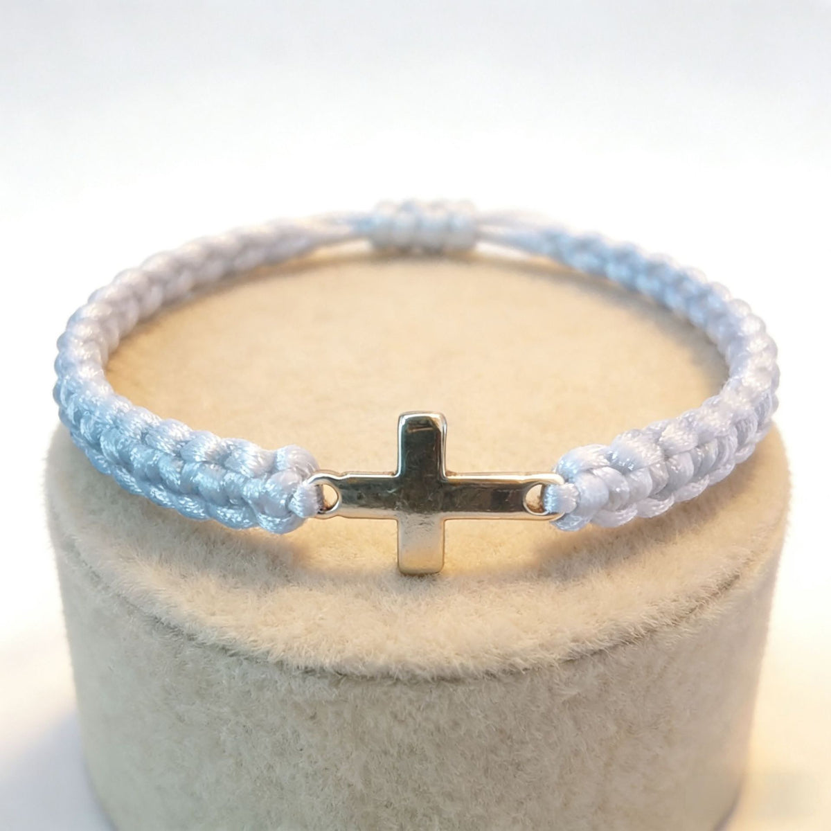 Adjustable sliding knot closure on black and white cross bracelet