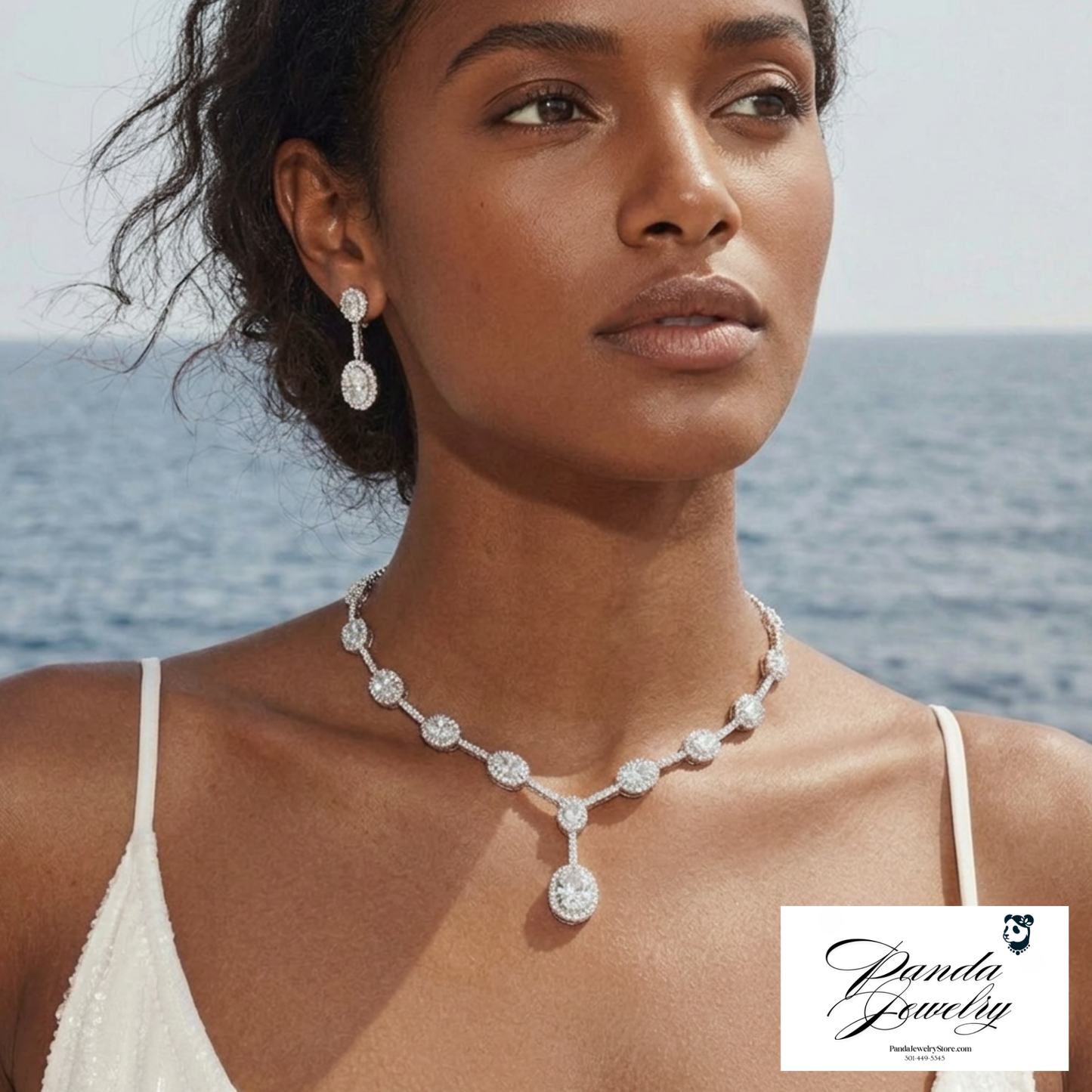 Woman wearing a diamond necklace and earrings with a scenic background