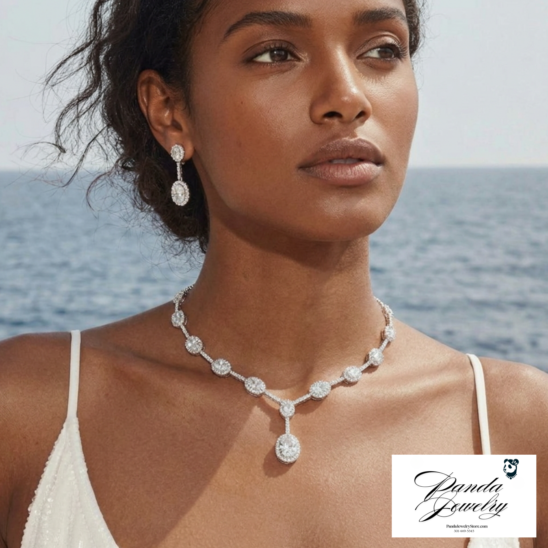 Woman wearing a diamond necklace and earrings with a scenic background