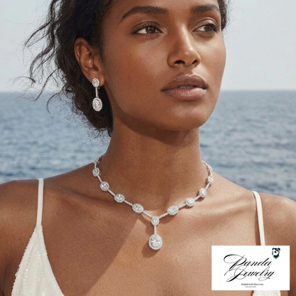 Woman wearing a diamond necklace and earrings with a scenic background