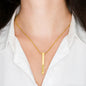 A women wearing a Custom Engraved 4-Sided Stick Necklace in a white blouse