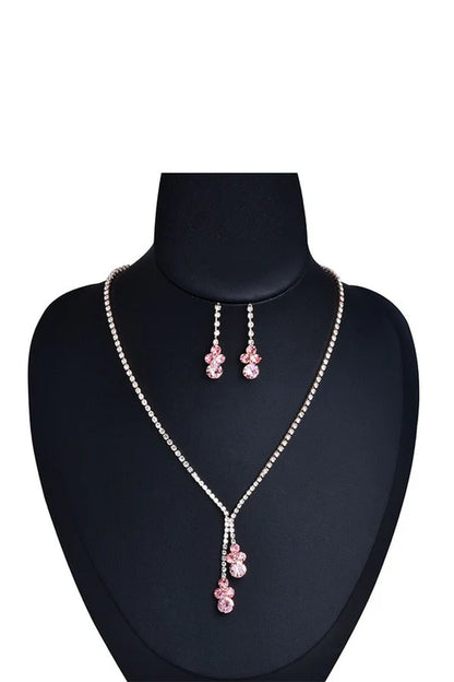 Elegant pink rhinestone necklace and earring set displayed on a black mannequin
