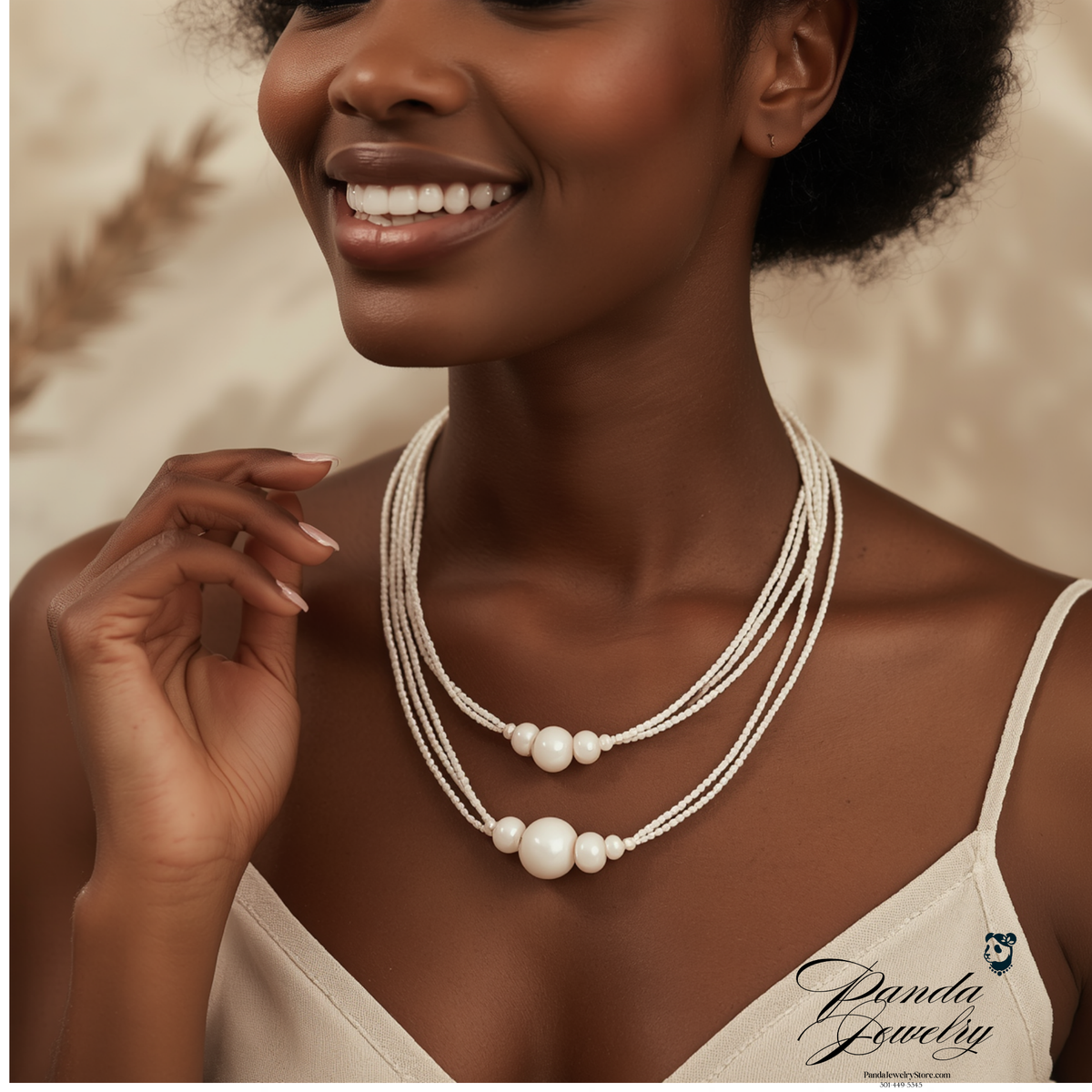 Sterling silver multi-strand necklace with three brushed round beads on cream background