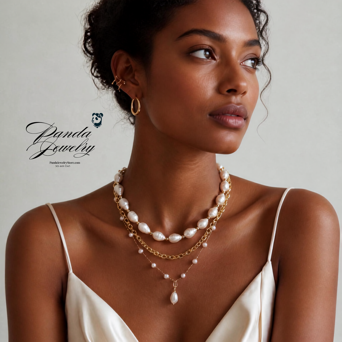Woman wearing a dual-layer baroque freshwater pearl necklace with 14K gold-plated chains, styled for everyday elegance