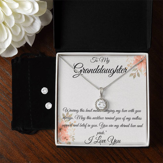 **Alt Text:**  
To My Granddaughter necklace and earring set with sparkling cubic zirconia, displayed in a floral gift box with a heartfelt message of love and pride.