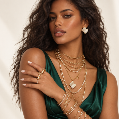 Wave Luxe Necklace and earring set worn by a woman with other layered jewelry.
